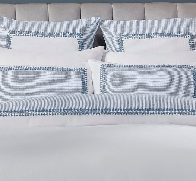 Elegant bedroom styled with crisp white and blue bedding made from premium European Linen. Soft textures and breathable fabric create a refined, hotel-inspired sleeping space.